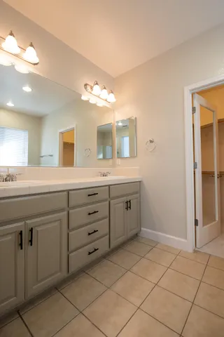 a spacious bathroom with a granite countertop sink a mirror and a
