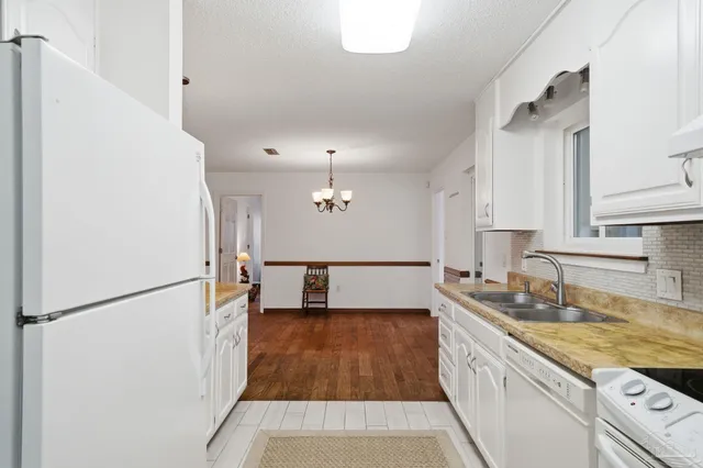 a kitchen with a refrigerator and a sink