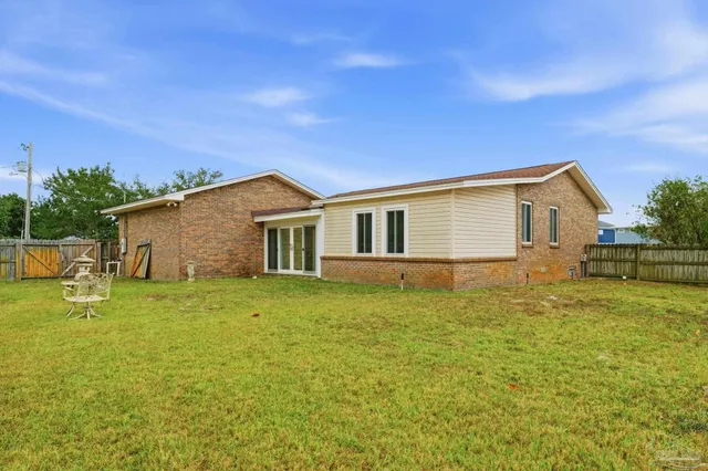 a view of a backyard with plants and a backyard