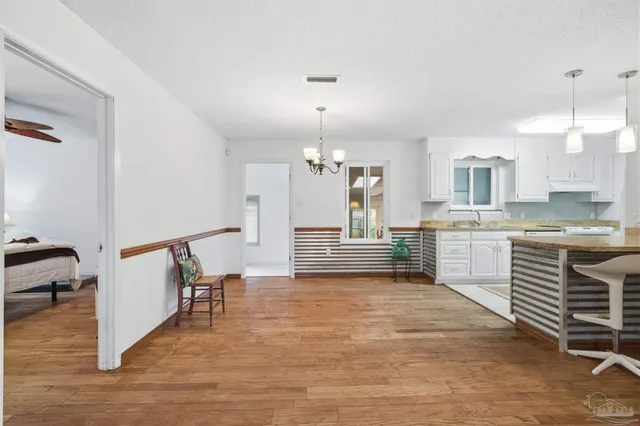 a view of a kitchen with a sink cabinets and wooden floor