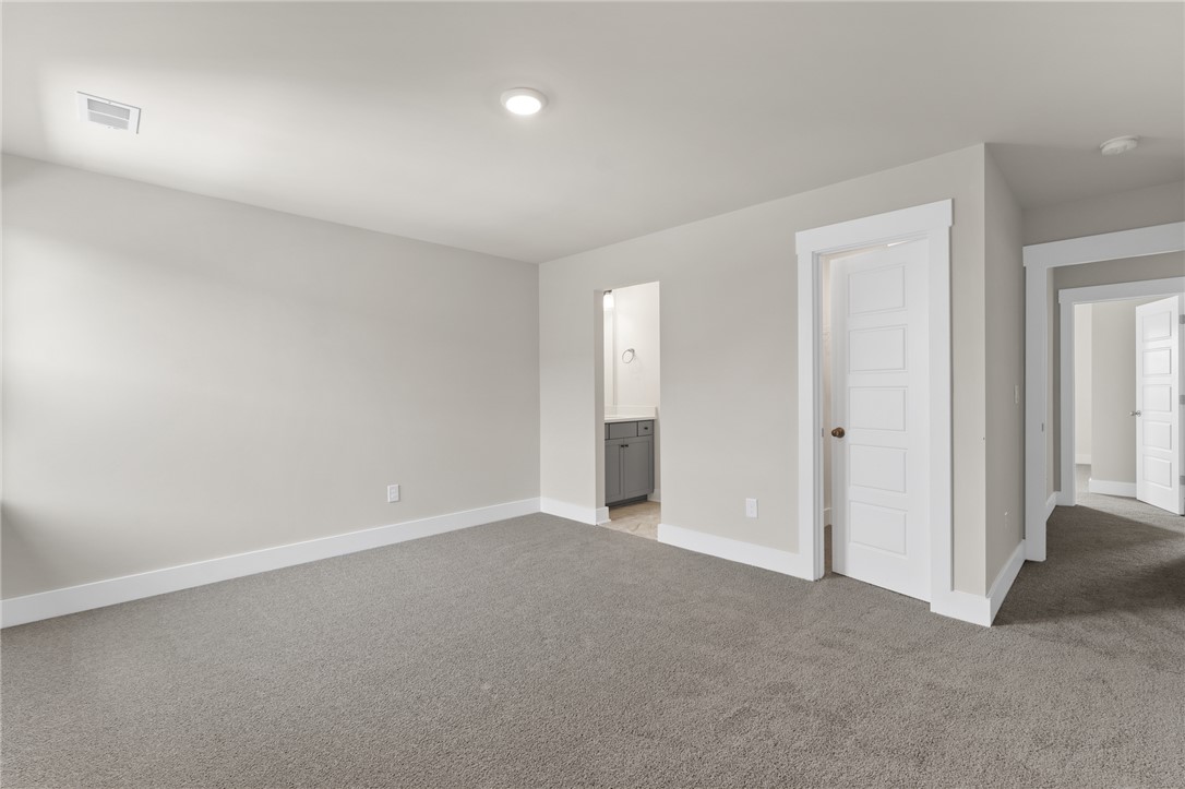 167 Tiger Lily Drive Anderson, SC 29621 - Photo 25 of 34 A spacious room offers comfortable carpeted flooring and recessed lighting.
