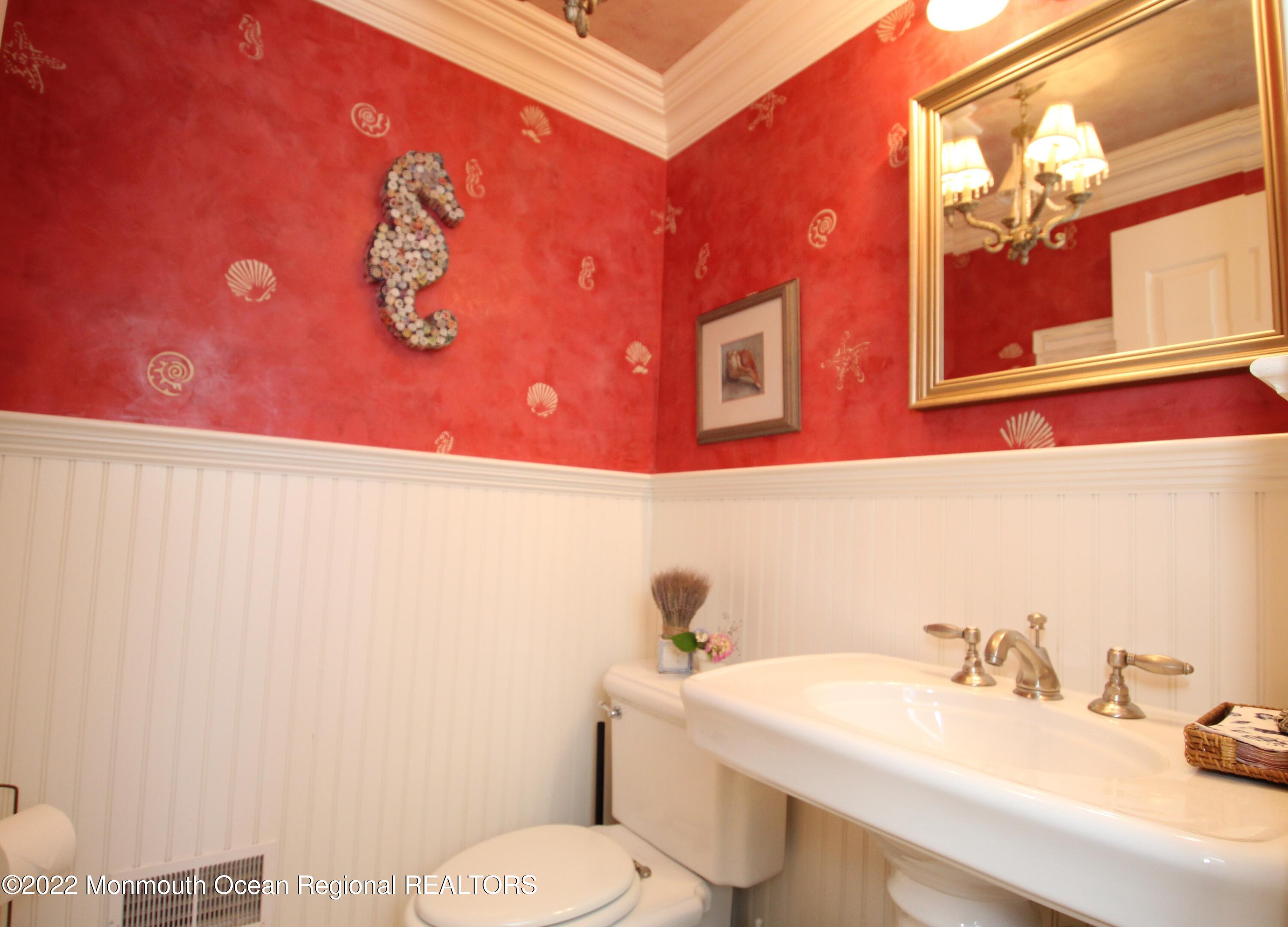 106 Stockton Boulevard Sea Girt, NJ 08750 - Photo 12 of 27 a bathroom with a sink a toilet and mirror