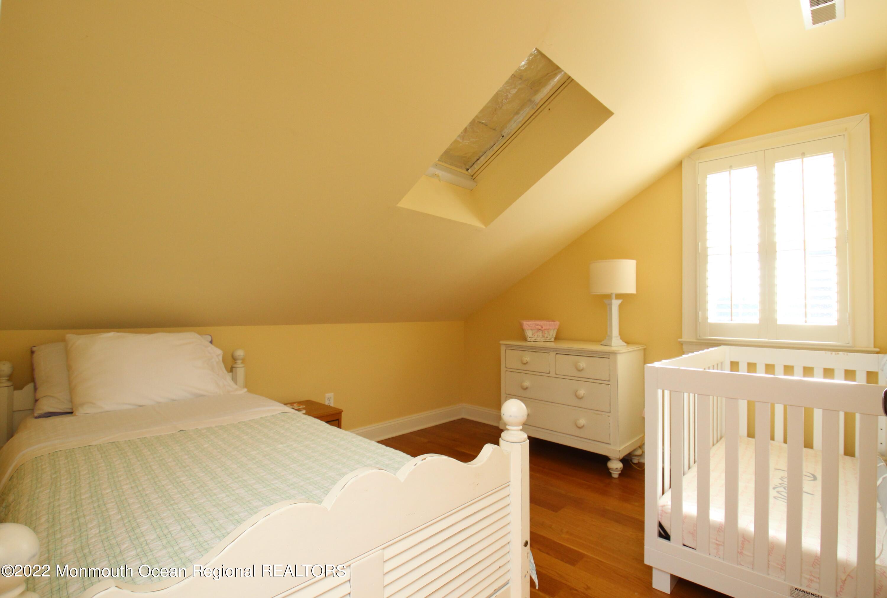 106 Stockton Boulevard Sea Girt, NJ 08750 - Photo 22 of 27 a bedroom with a bed and cabinets