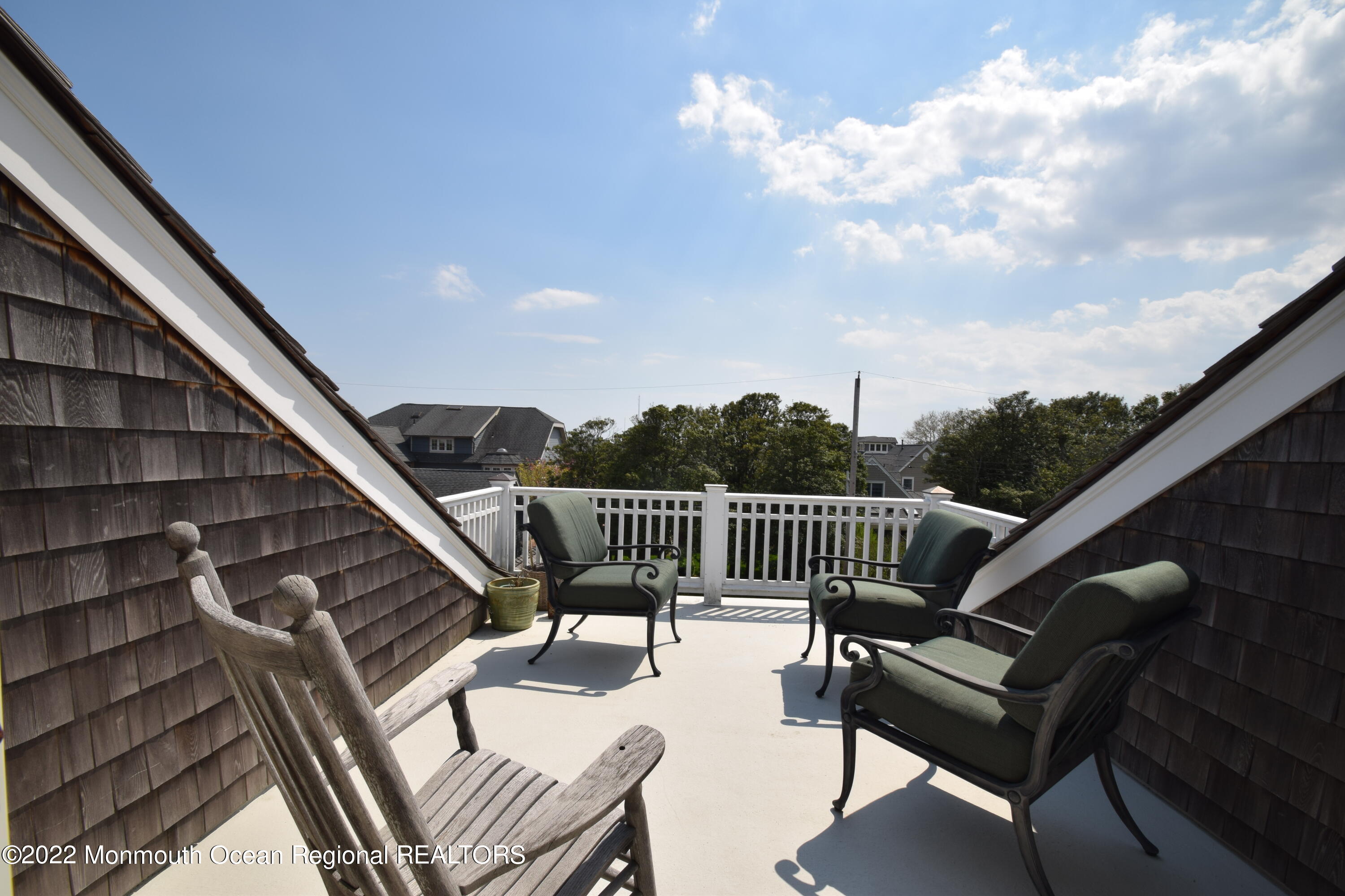 106 Stockton Boulevard Sea Girt, NJ 08750 - Photo 23 of 27 a balcony with wooden floor stairs and furniture