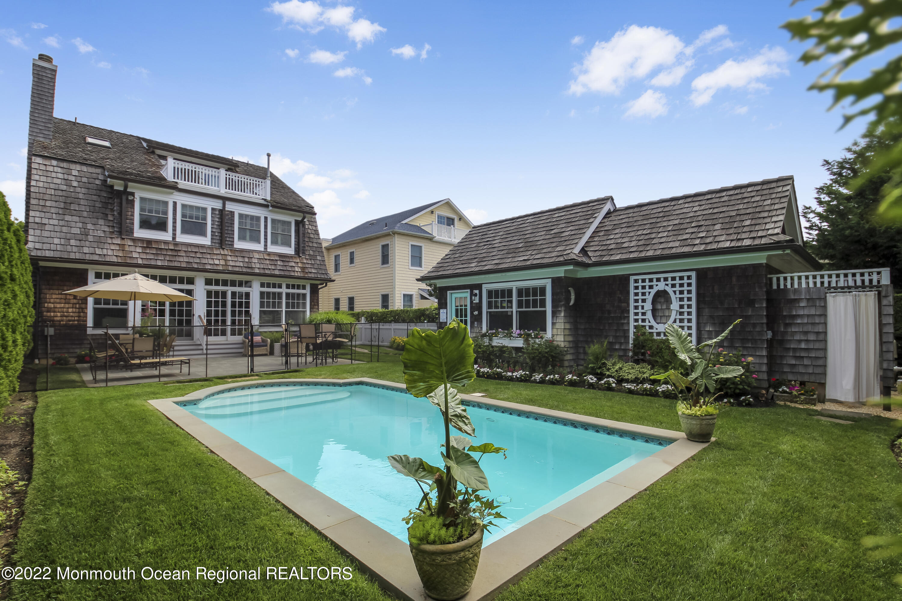 106 Stockton Boulevard Sea Girt, NJ 08750 - Photo 24 of 27 a front view of a house with a yard table and chairs