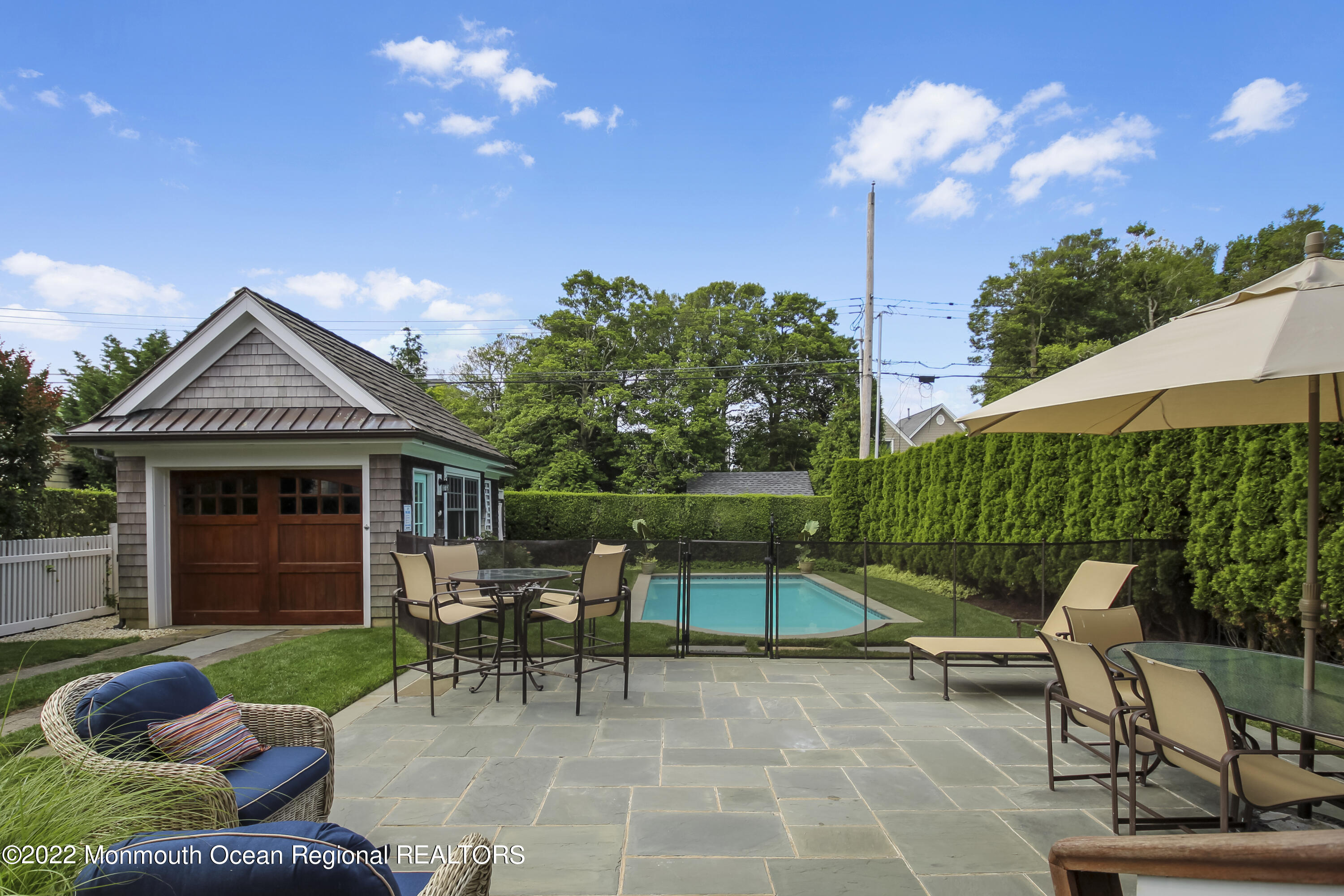 106 Stockton Boulevard Sea Girt, NJ 08750 - Photo 26 of 27 a view of a chair and tables in the patio in front of a house