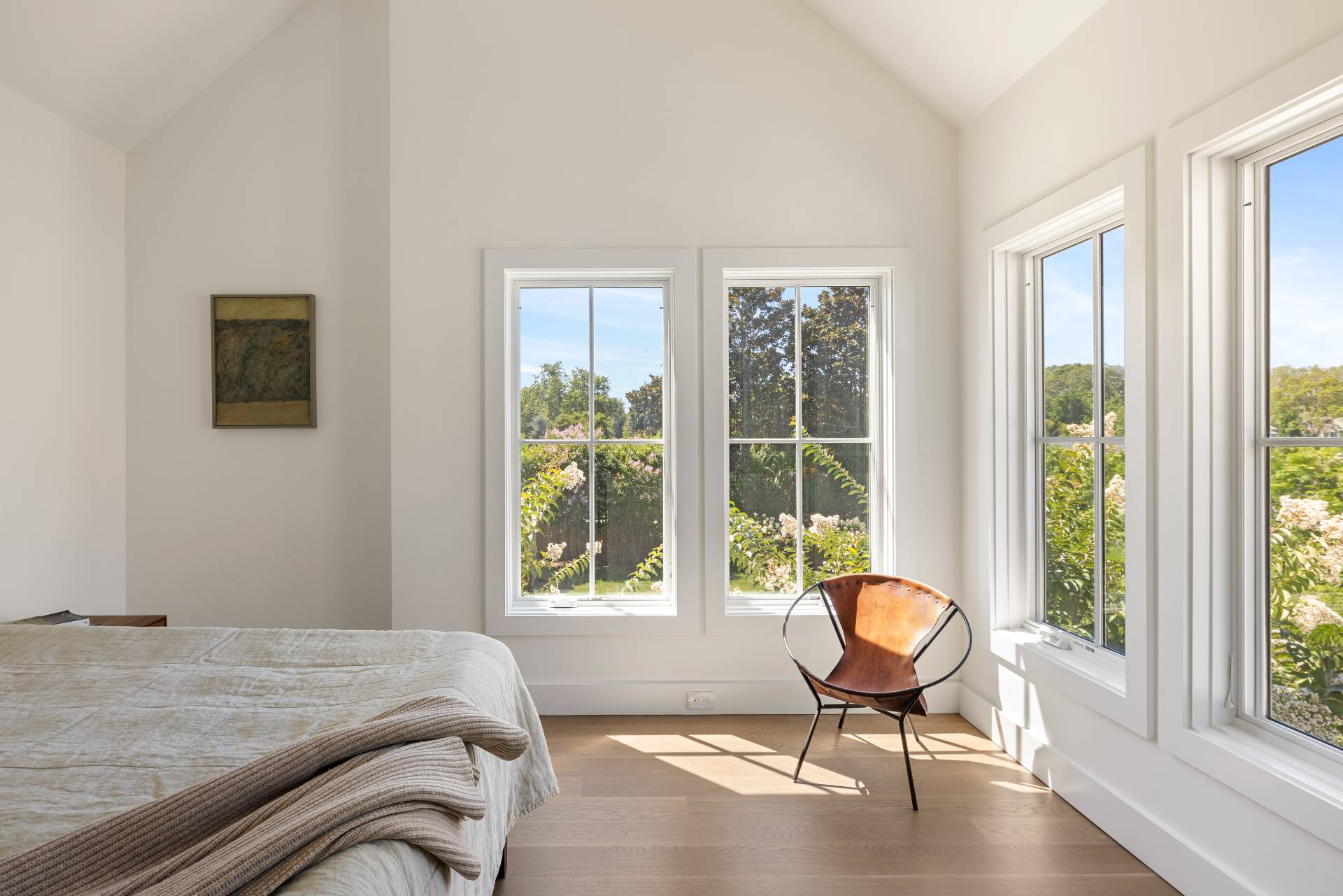 222 White Street Southampton, NY 11968 - Photo 14 of 28 a bedroom with a bed and chair next to a window