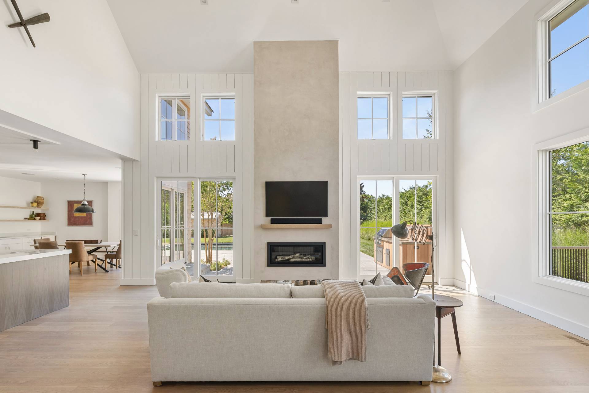 222 White Street Southampton, NY 11968 - Photo 4 of 28 a living room with furniture a flat screen tv and a fireplace