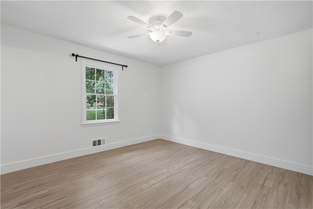 125 Childers Road Canton, GA 30115 - Photo 34 of 48 an empty room with wooden floor and windows
