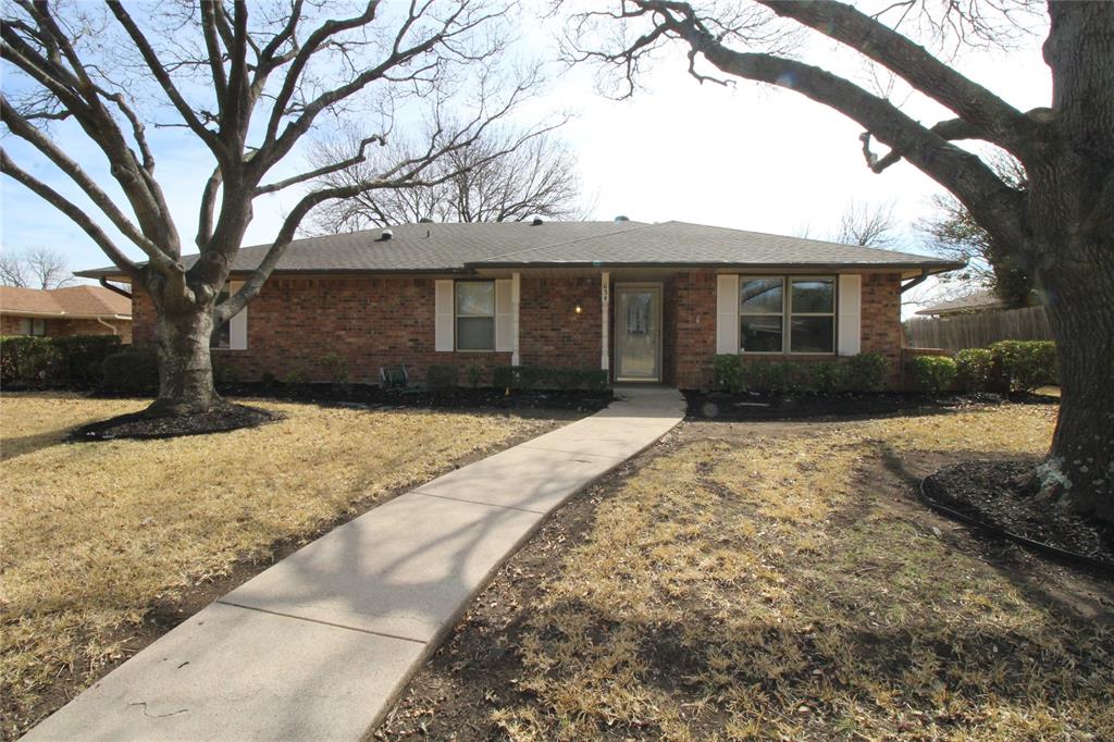 Ranch-style house with fence, a front lawn, and brick siding