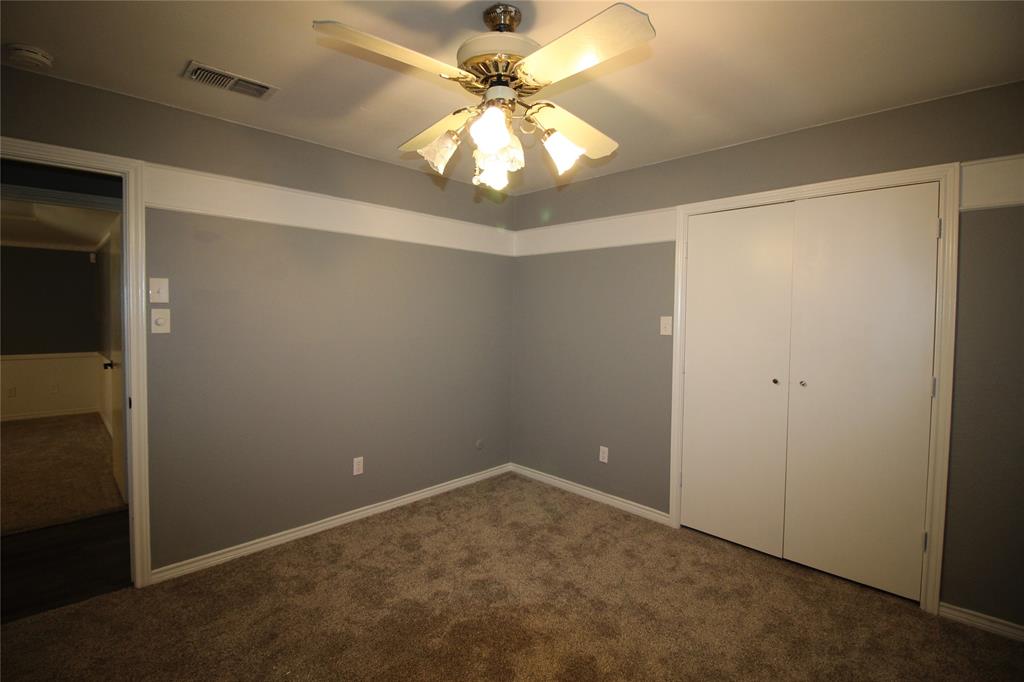 634 Ray Avenue DeSoto, TX 75115 - Photo 13 of 28 Unfurnished bedroom featuring a closet, carpet floors, visible vents, and baseboards