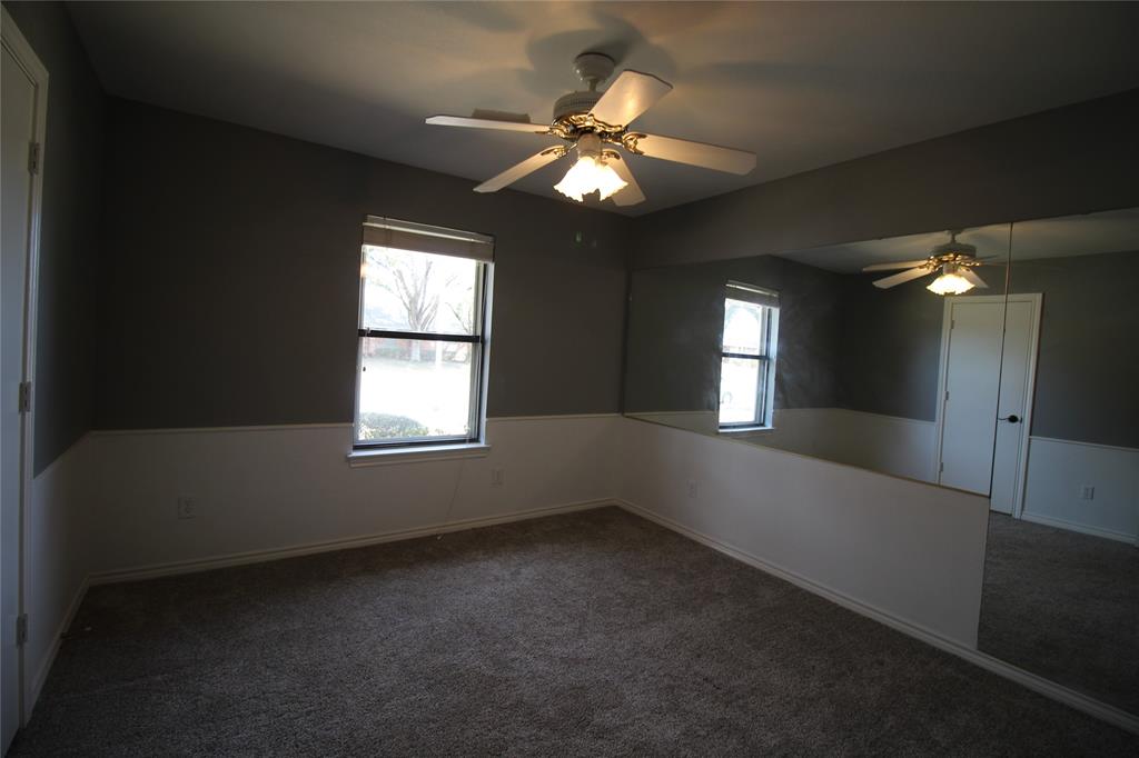 634 Ray Avenue DeSoto, TX 75115 - Photo 15 of 28 Spare room with ceiling fan, baseboards, and dark colored carpet