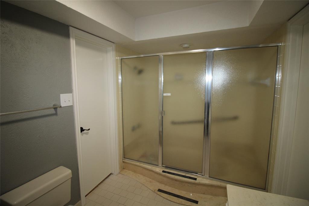 634 Ray Avenue DeSoto, TX 75115 - Photo 19 of 28 Bathroom featuring a shower stall, tile patterned flooring, and toilet