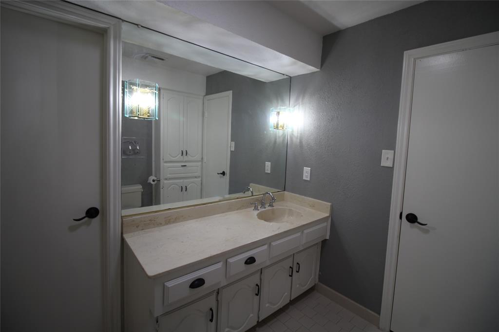 634 Ray Avenue DeSoto, TX 75115 - Photo 20 of 28 Bathroom featuring visible vents, baseboards, vanity, and tile patterned flooring