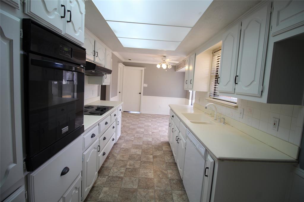 634 Ray Avenue DeSoto, TX 75115 - Photo 23 of 28 Kitchen with a sink, dishwasher, black electric stovetop, light countertops, and under cabinet range hood