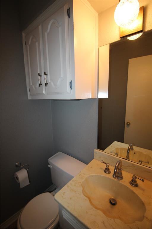 634 Ray Avenue DeSoto, TX 75115 - Photo 24 of 28 Half bathroom with vanity and toilet