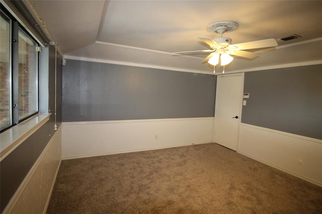634 Ray Avenue DeSoto, TX 75115 - Photo 9 of 28 Unfurnished room featuring visible vents, a ceiling fan, carpet flooring, and vaulted ceiling