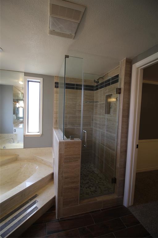 634 Ray Avenue DeSoto, TX 75115 - Photo 10 of 28 Full bath with a shower stall, a textured ceiling, and vanity