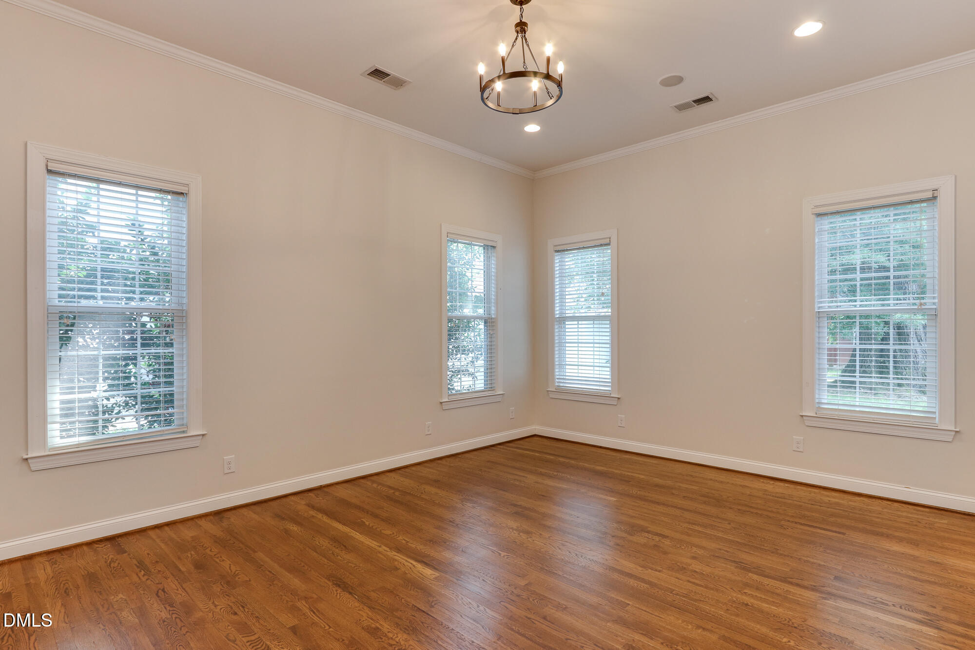 604 Mills Street Raleigh, NC 27608 - Photo 15 of 39 a view of an empty room with wooden floor and a window