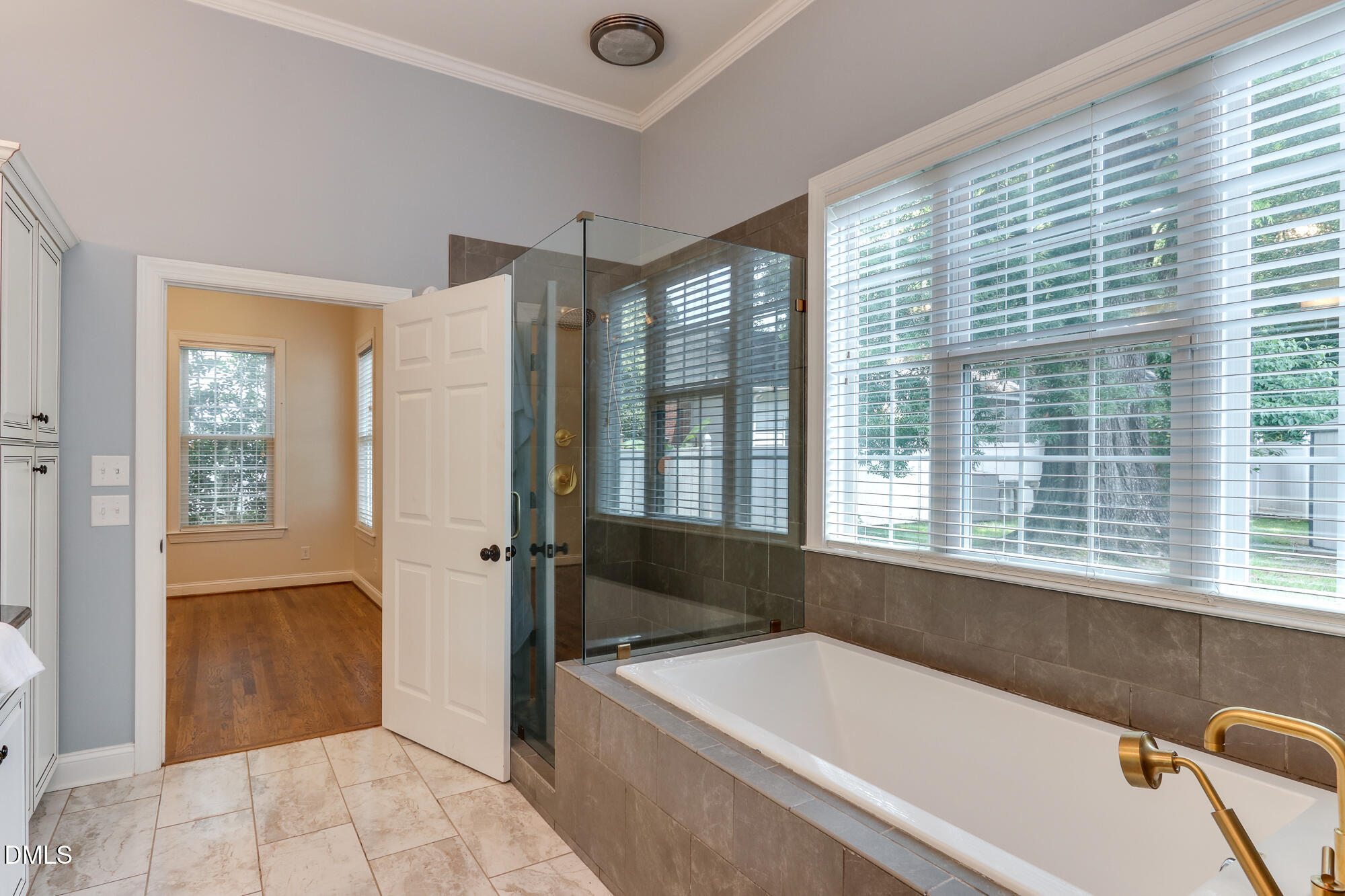 604 Mills Street Raleigh, NC 27608 - Photo 18 of 39 a bathroom with a tub a sink and a window