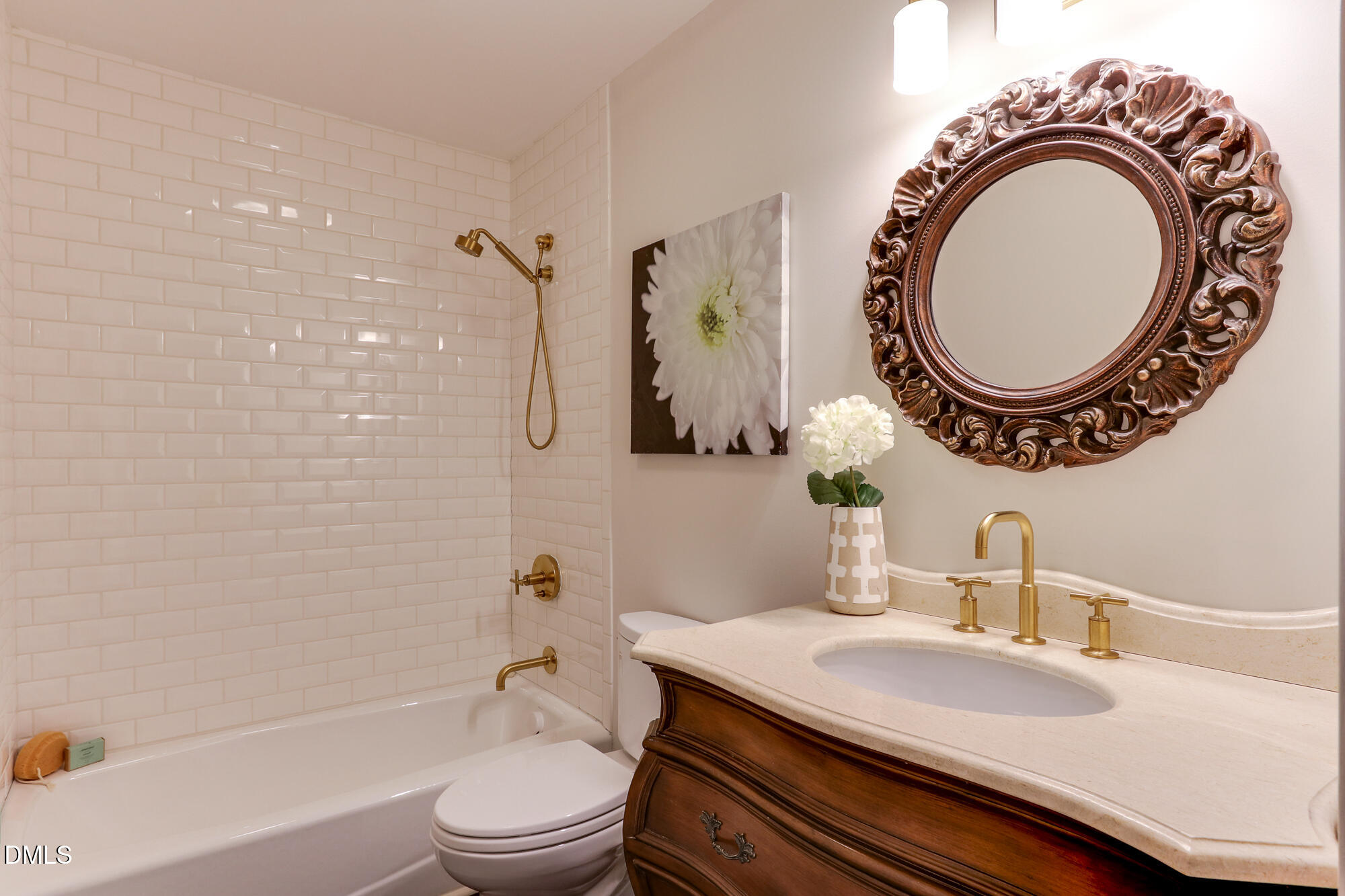 604 Mills Street Raleigh, NC 27608 - Photo 22 of 39 a bathroom with a granite countertop toilet a sink and a bathtub