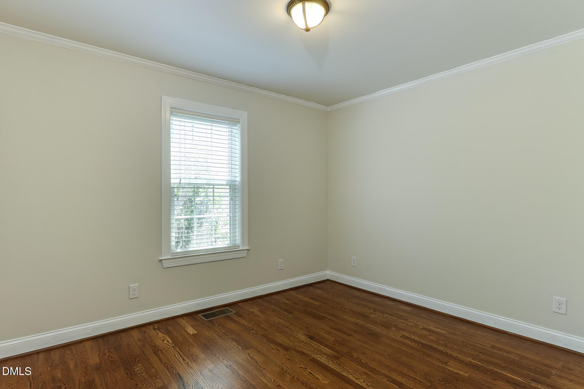 604 Mills Street Raleigh, NC 27608 - Photo 23 of 39 an empty room with wooden floor and windows
