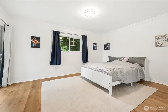 a spacious bedroom with a bed and a window