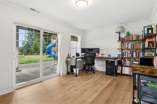 a view of a workspace with furniture and a window