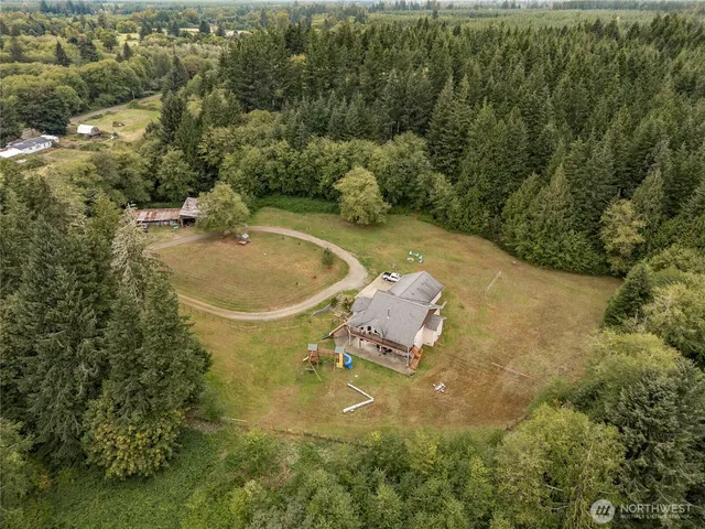an aerial view of a house with a yard