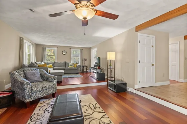 a living room with furniture and wooden floor