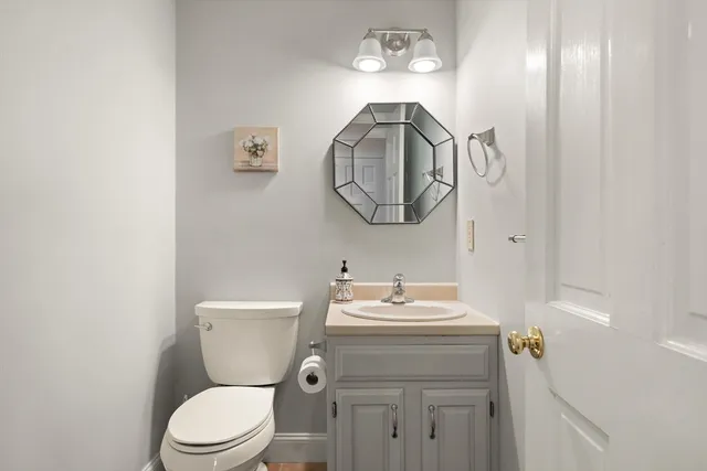 a bathroom with a sink a toilet and a mirror