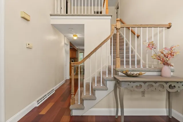 a view of entryway and hall with wooden floor