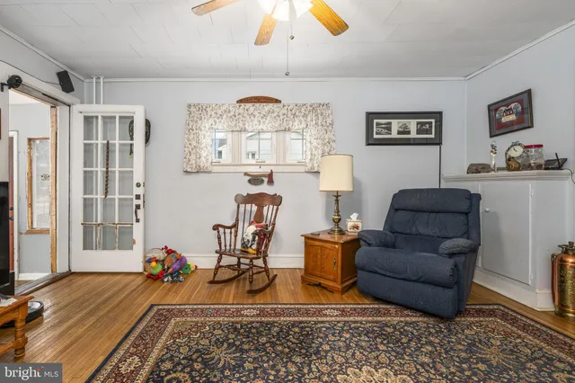 a living room with furniture a chandelier and a rug