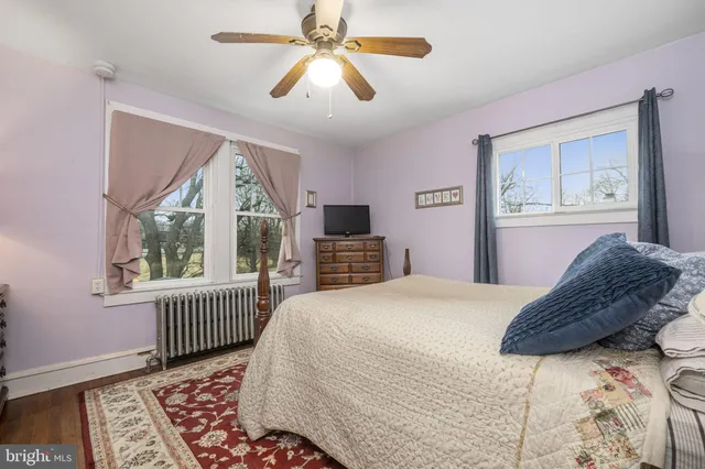 a bedroom with a bed dresser and a window
