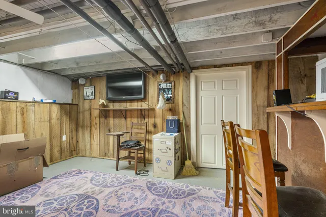 a bedroom with furniture and a flat screen tv