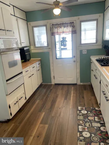 a kitchen with granite countertop cabinets stainless steel appliances and a counter