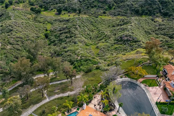 an aerial view of a houses with yard