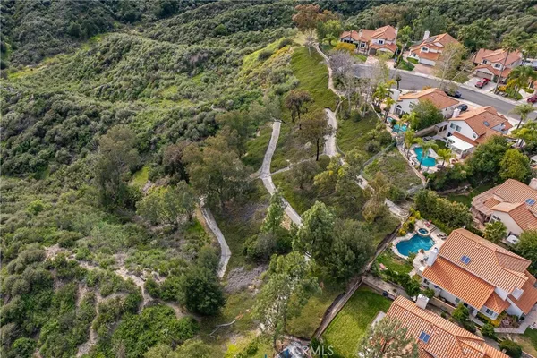 an aerial view of residential house with green space