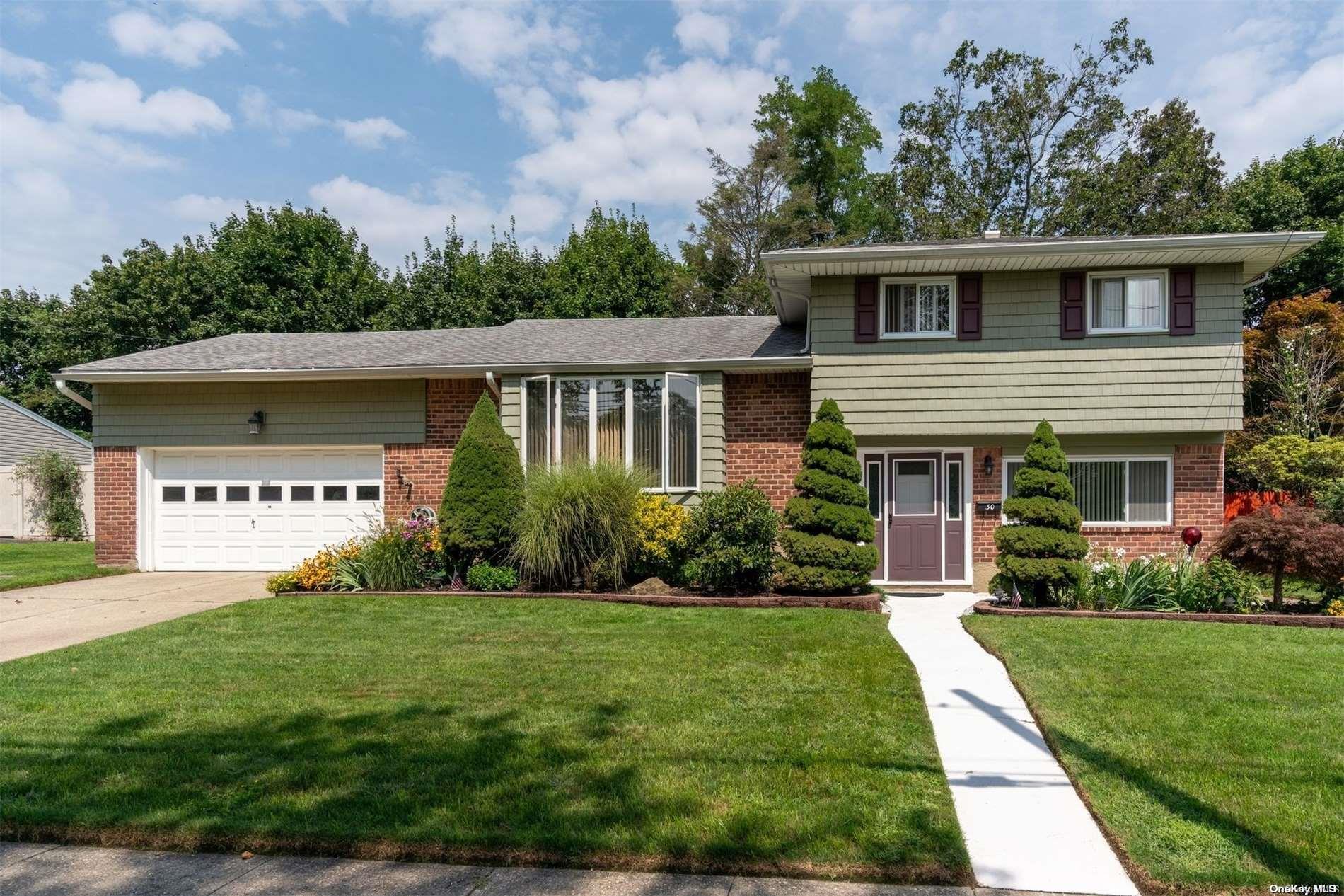 30 Wheatfield Lane Commack, NY 11725 - Photo 1 of 1 a front view of a house with a yard