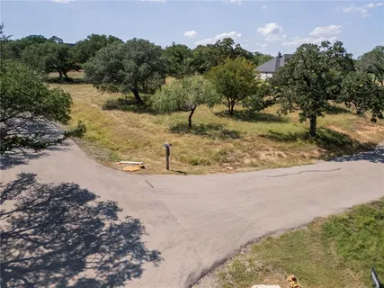 a view of a yard with a tree