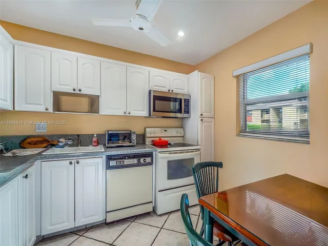 a kitchen with stainless steel appliances granite countertop a stove a sink dishwasher and a refrigerator