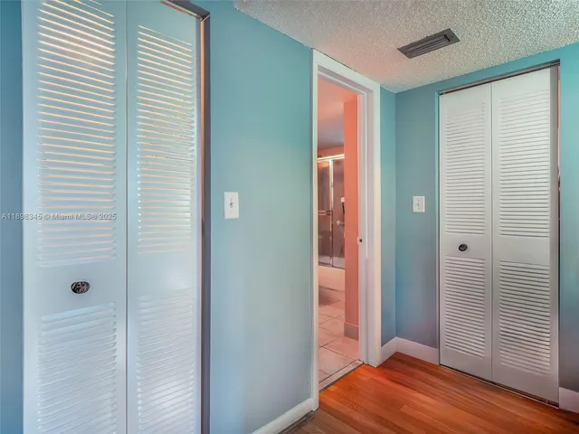a view of a room with wooden floor