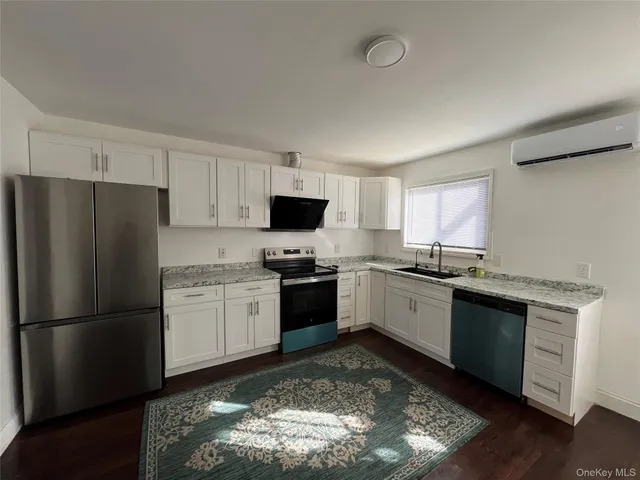 a view of a room with wooden floor and a sink