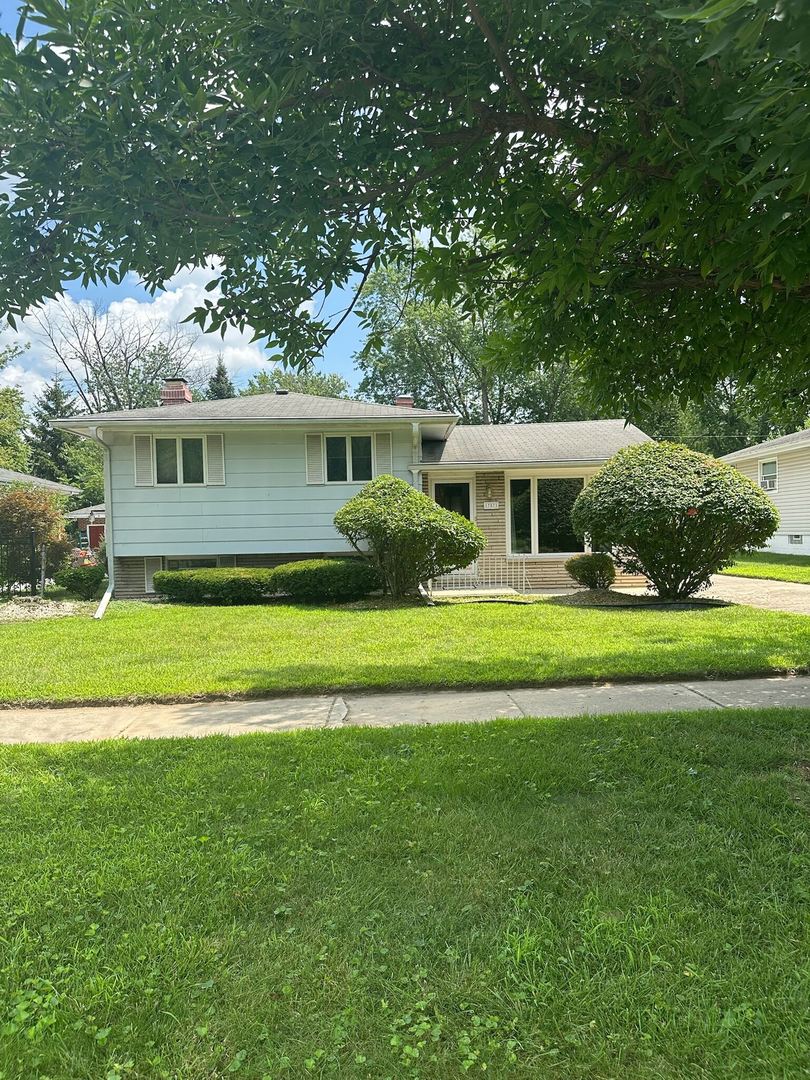 17871 Locust Street Lansing, IL 60438 - Photo 1 of 25 a front view of house with yard and green space