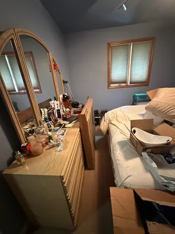 a bed sitting in a bedroom next to a window