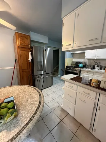 a kitchen with stainless steel appliances kitchen island granite countertop a refrigerator sink and cabinets