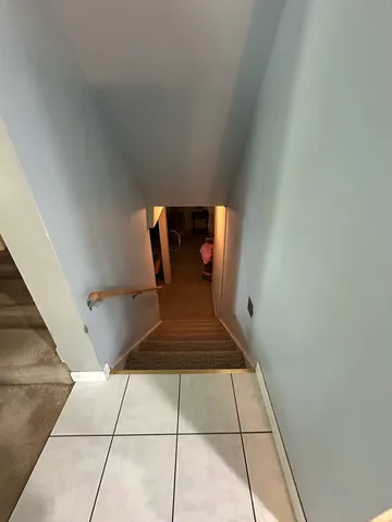 a view of an empty room with a bench