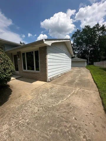 a view of a house with a yard and garage