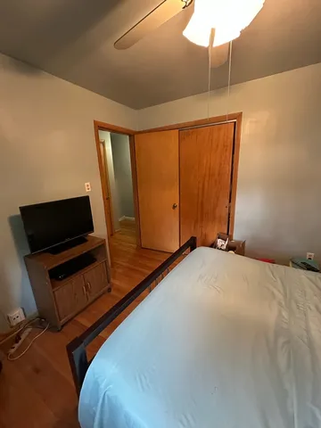 a bed room with a bed tv and a mirror