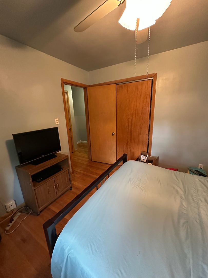 17871 Locust Street Lansing, IL 60438 - Photo 10 of 25 a bed room with a bed tv and a mirror